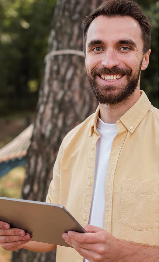 Man smiling with tablet